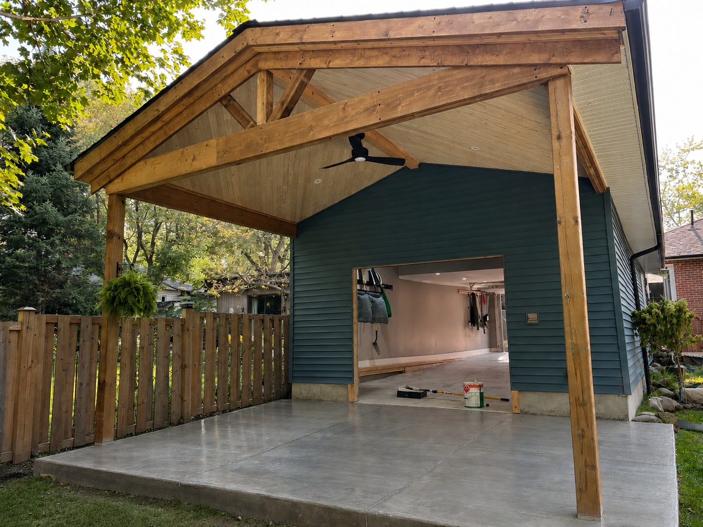 Covered patio with exposed timber gable roof and concrete slab, built by Kopman Build
