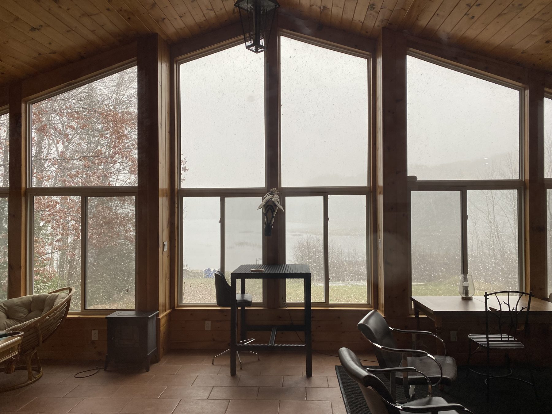 Muskoka room with tall gabled windows, wood-panelled ceiling and tile floor in Gravenhurst, Ontario, built by Kopman Build in 2025